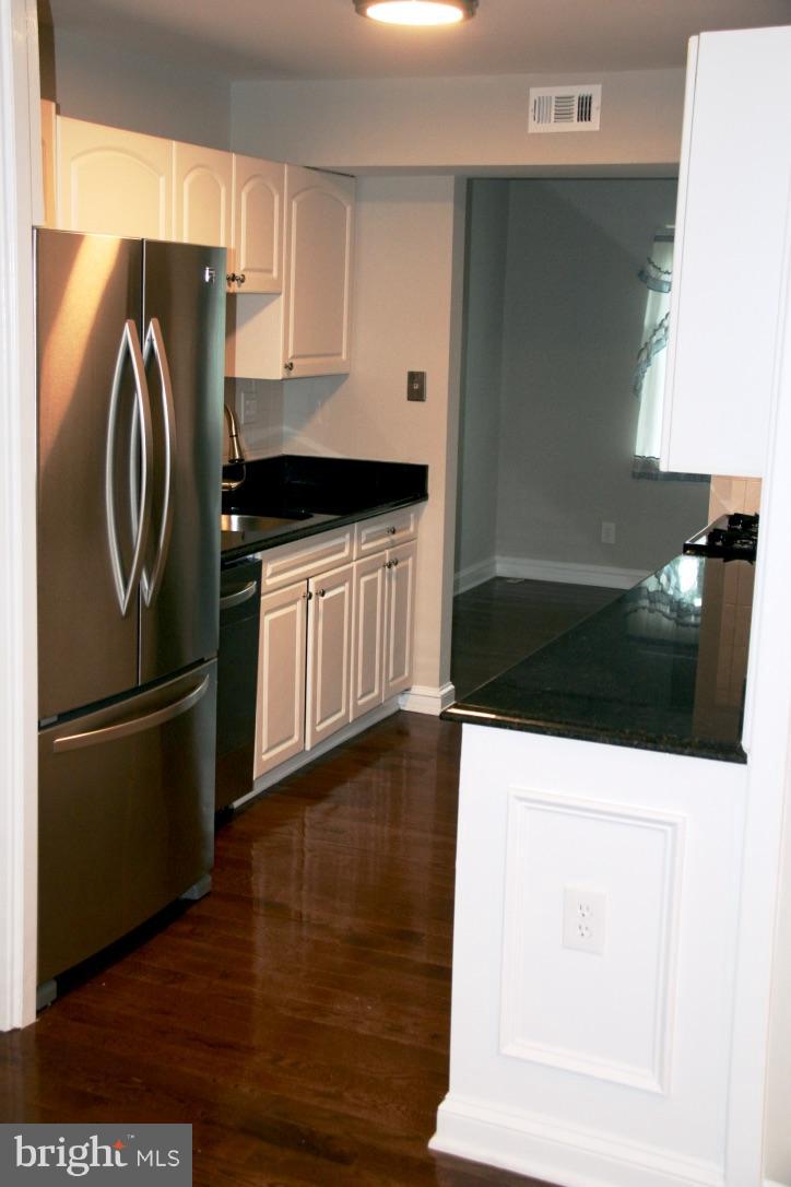 581 Summit Hall Road Gaithersburg, MD 20877 - Photo 5 of 22 a kitchen with stainless steel appliances kitchen island granite countertop a refrigerator a stove and a sink