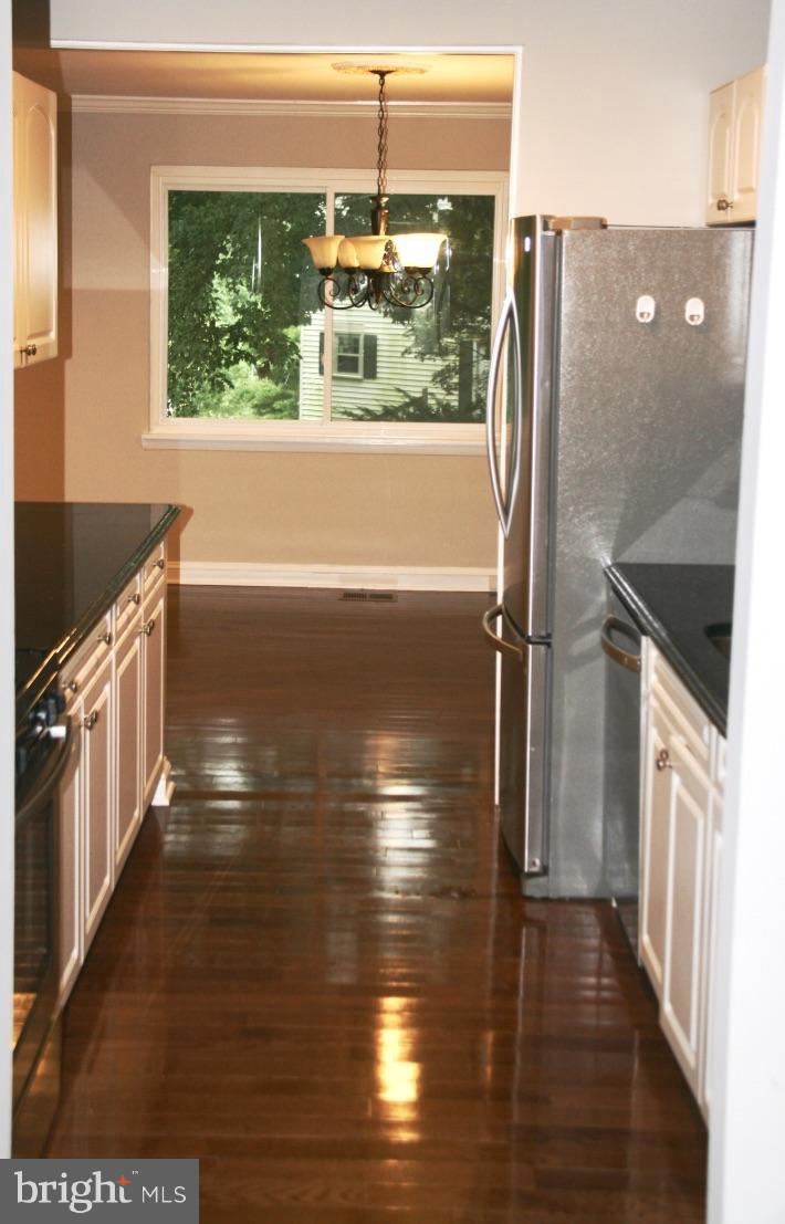 581 Summit Hall Road Gaithersburg, MD 20877 - Photo 7 of 22 a view of lot of kitchen and hall with wooden floor