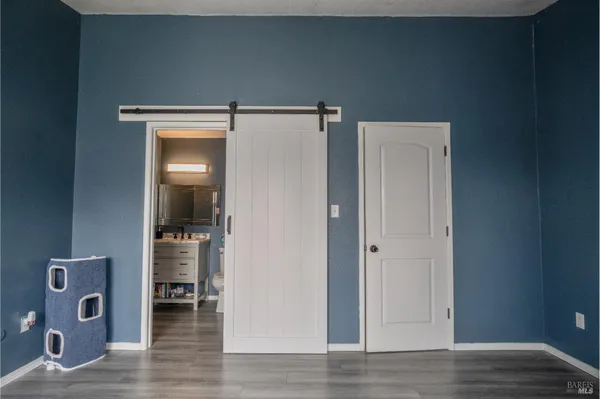 a view of a hallway with wooden floor