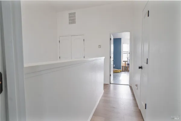 a bedroom with furniture and a large window