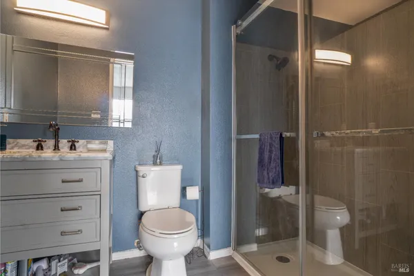 a bathroom with a toilet sink and shower