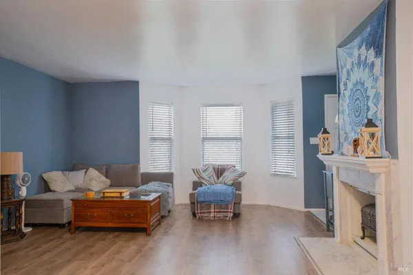 a living room with furniture and a fireplace