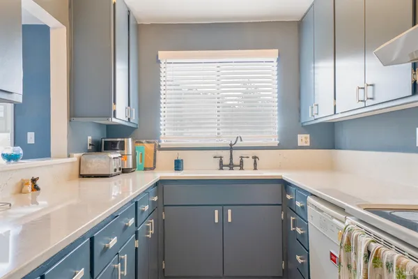 a kitchen with a sink cabinets and window
