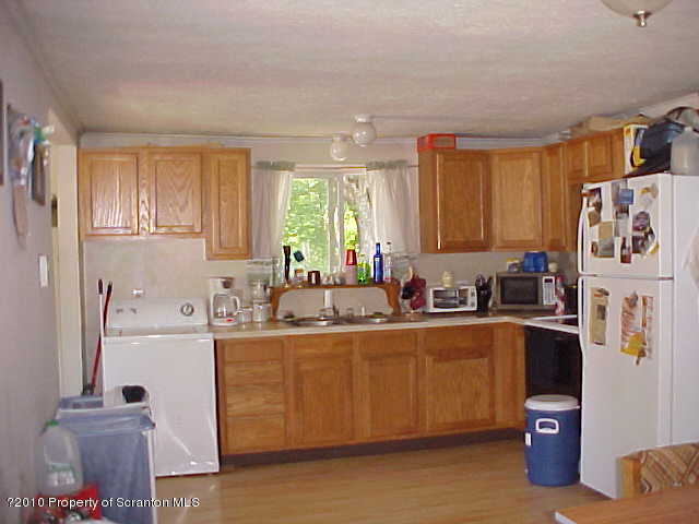 40 Orchard Road Great Bend, PA 18821 - Photo 4 of 8 a kitchen with stainless steel appliances granite countertop a refrigerator sink and cabinets