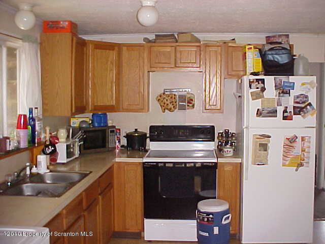 40 Orchard Road Great Bend, PA 18821 - Photo 8 of 8 a kitchen with stainless steel appliances a stove a sink and a refrigerator