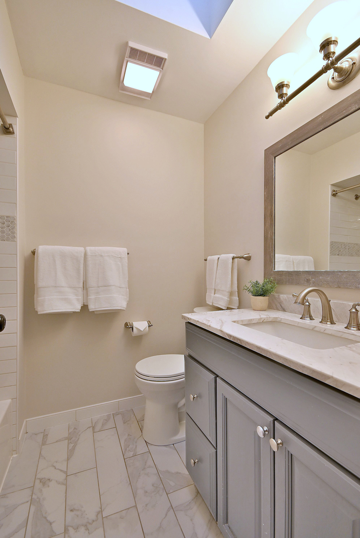 366 Marion Street Elmhurst, IL 60126 - Photo 15 of 41 a bathroom with a granite countertop sink and a toilet