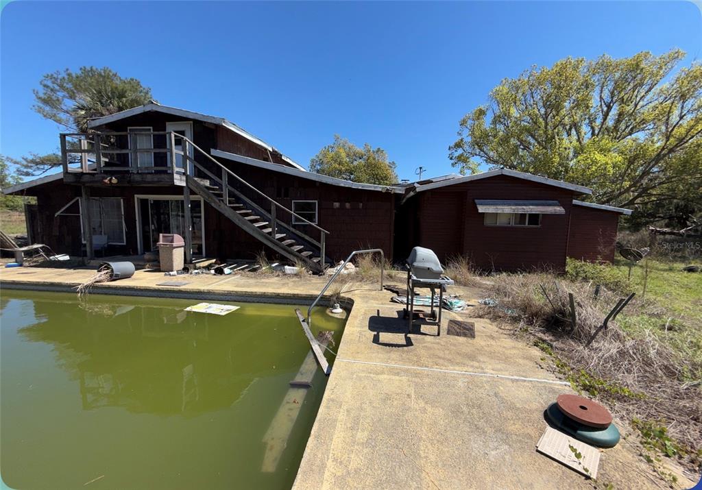 9844 Poe Street Leesburg, FL 34788 - Photo 18 of 32 a view of a swimming pool with chairs