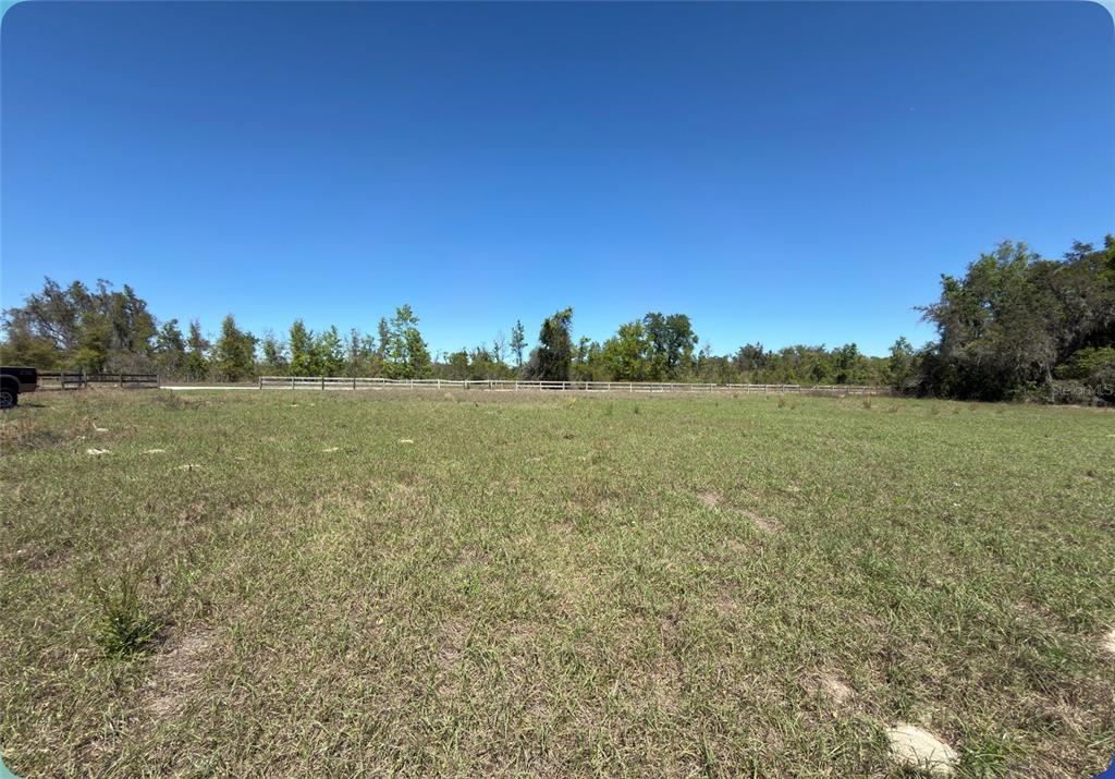 9844 Poe Street Leesburg, FL 34788 - Photo 22 of 32 a view of a field with trees in the background