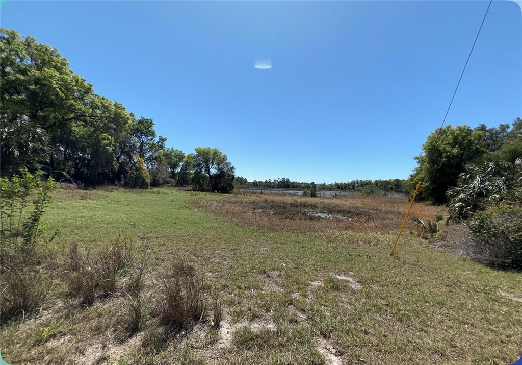 9844 Poe Street Leesburg, FL 34788 - Photo 25 of 32 a view of a lake with a yard