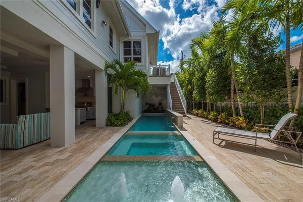 a view of a house with backyard and sitting area