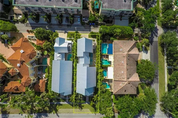 an aerial view of houses with yard