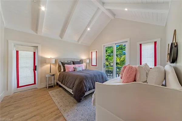 a bedroom with a large bed and a large window