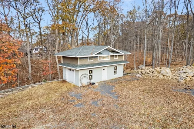 a white house that has a tree in front of it