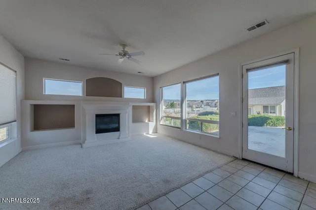an empty room with closet and fan