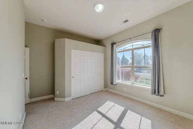 a spacious bathroom with a double vanity sink and a mirror