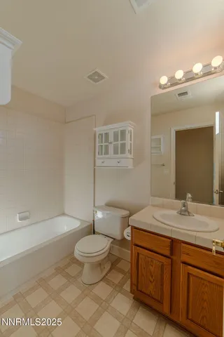 a bathroom with a tub shower and sink