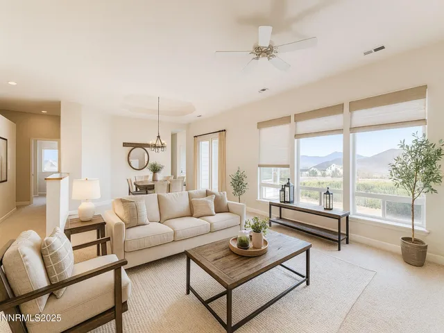 a living room with furniture a chandelier and a window