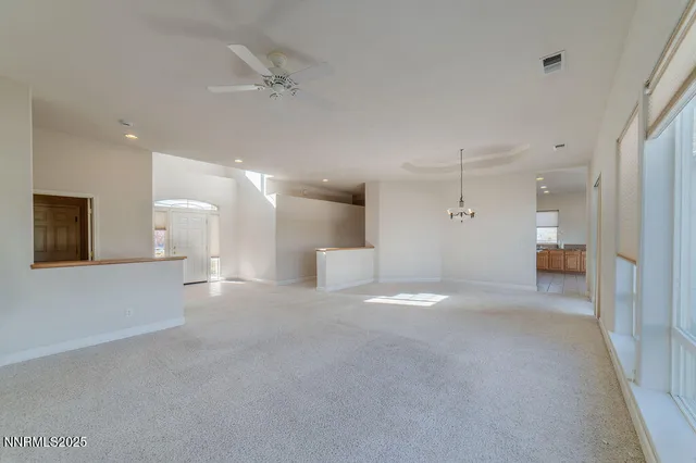 a view of an empty room with a fireplace and a window