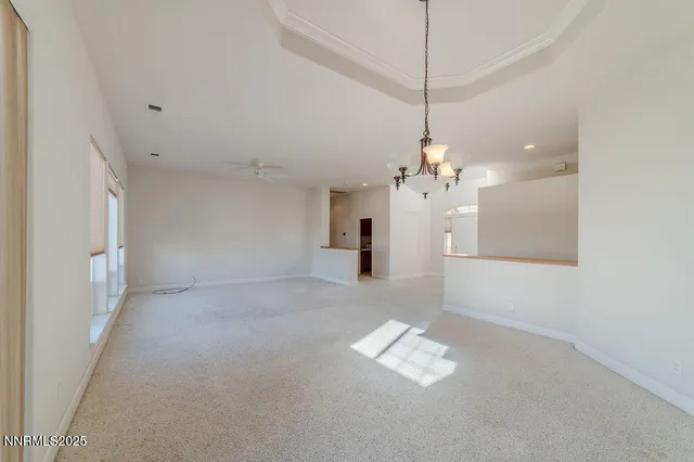 a kitchen with stainless steel appliances a sink a stove a refrigerator cabinets and a dining table