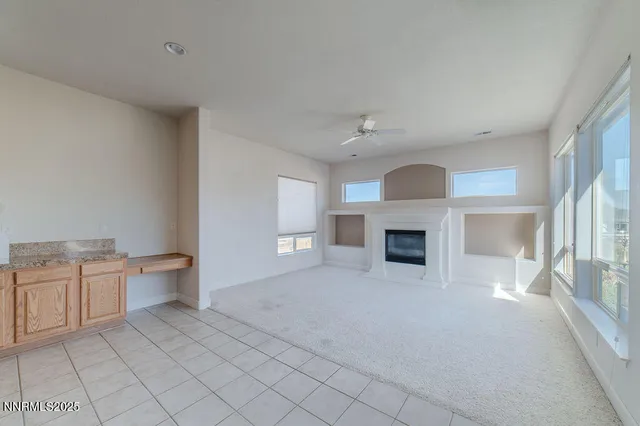 a kitchen with granite countertop a sink cabinets and window