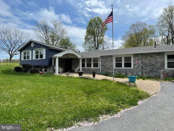 a front view of a house with a garden and porch
