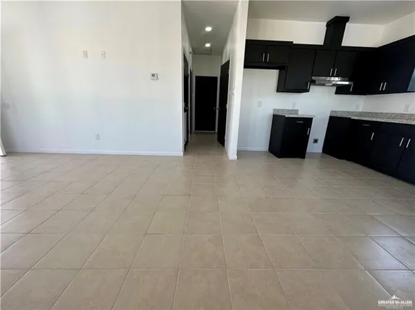 a view of kitchen with stainless steel appliances a sink and cabinets
