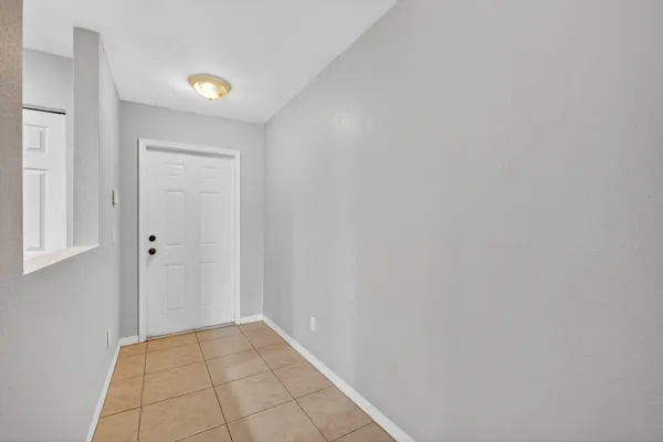 a view of an empty room and closet area