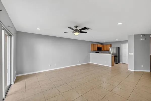 a view of a livingroom with a ceiling fan and wooden floor