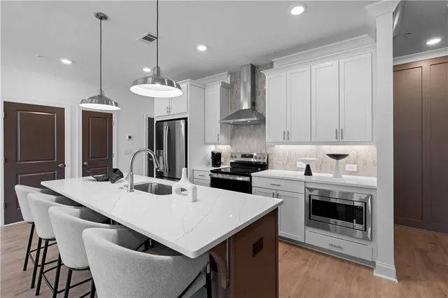 a kitchen with a stove a sink and a refrigerator