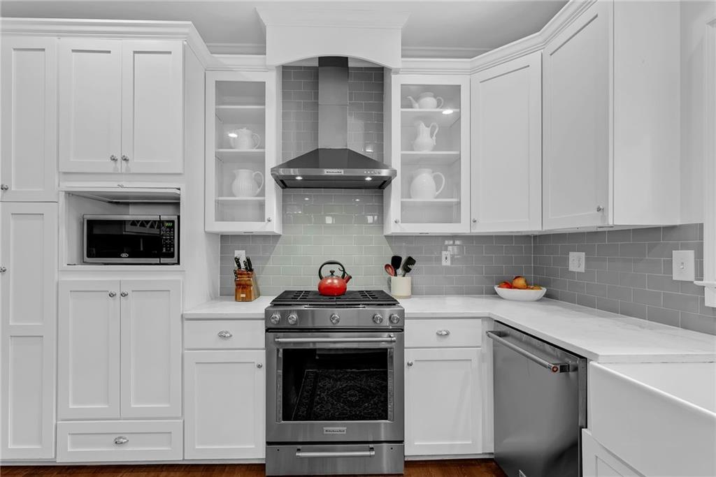 411 Chelsea Circle Northeast Atlanta, GA 30307 - Photo 20 of 42 a kitchen with white cabinets and white appliances
