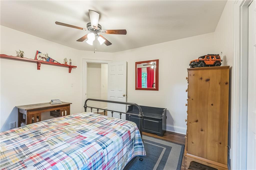 411 Chelsea Circle Northeast Atlanta, GA 30307 - Photo 30 of 42 a bedroom with a bed and a chandelier