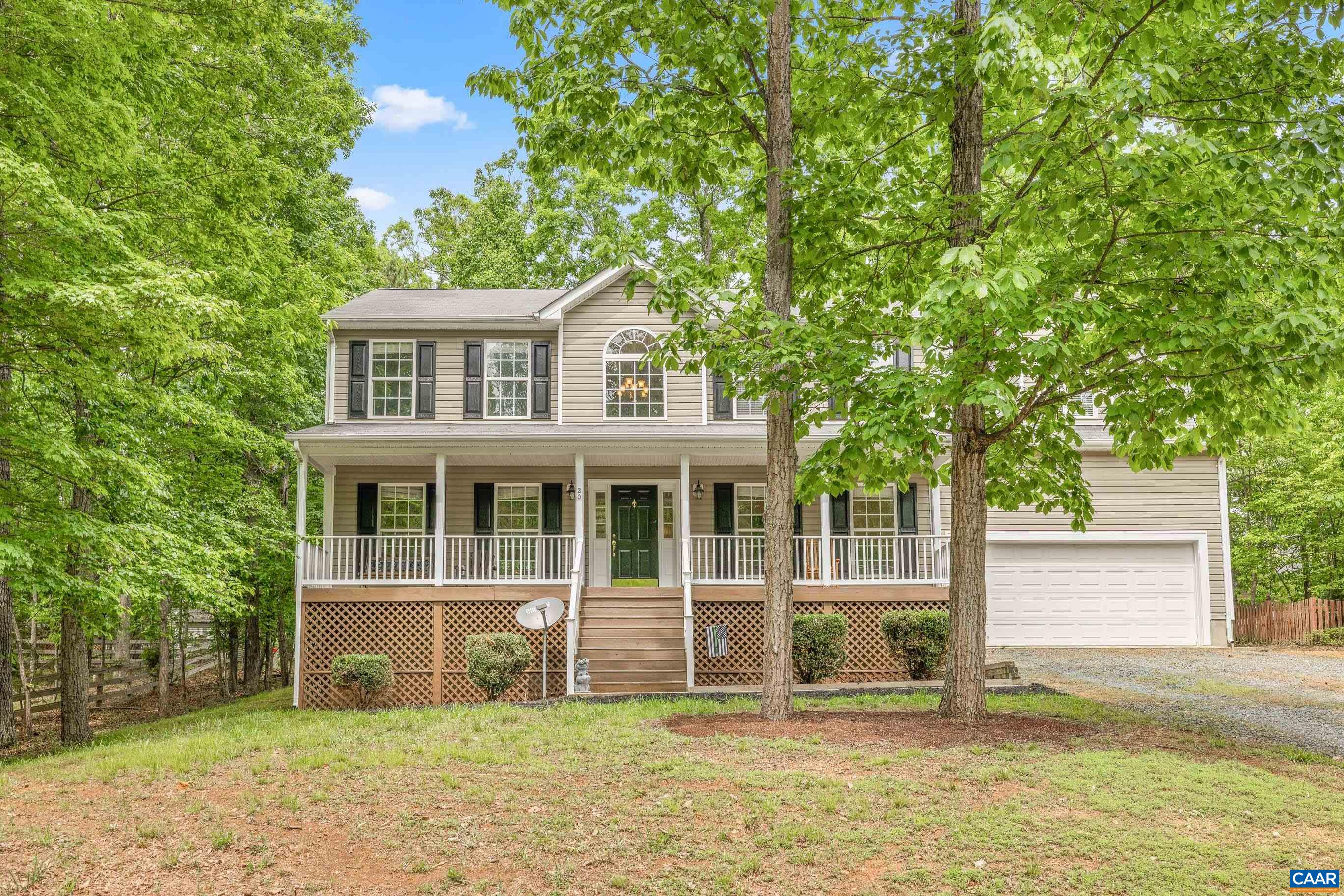 a house that has a tree in front of it