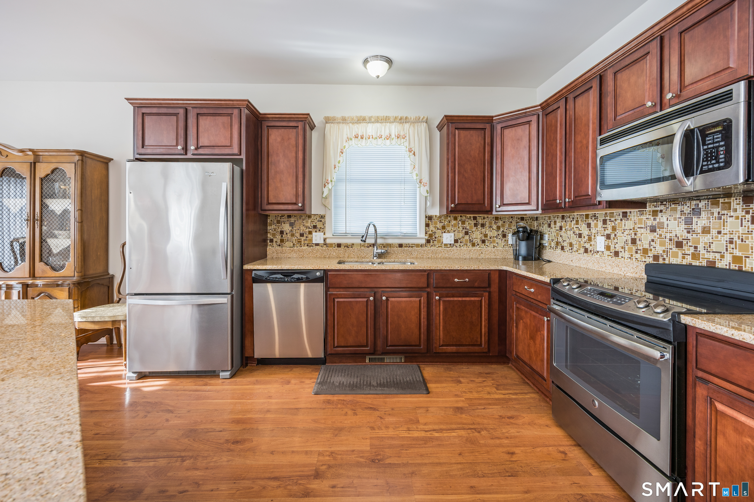 39 Phillips Farm Road, Unit 39 East Hartford, CT 06118 - Photo 2 of 32 a kitchen with stainless steel appliances granite countertop a stove refrigerator sink and dishwasher