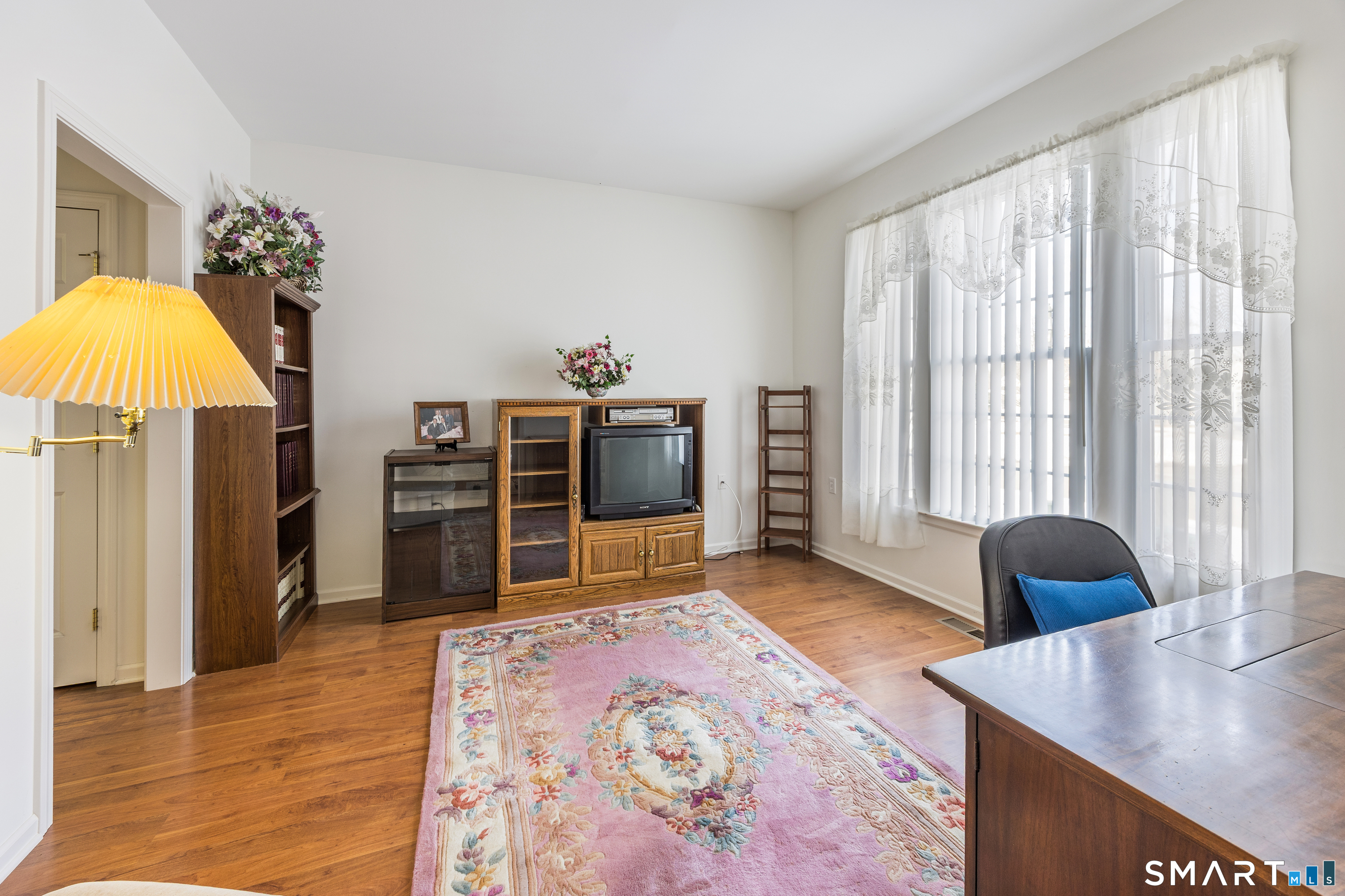 39 Phillips Farm Road, Unit 39 East Hartford, CT 06118 - Photo 7 of 32 a living room with furniture and a flat screen tv