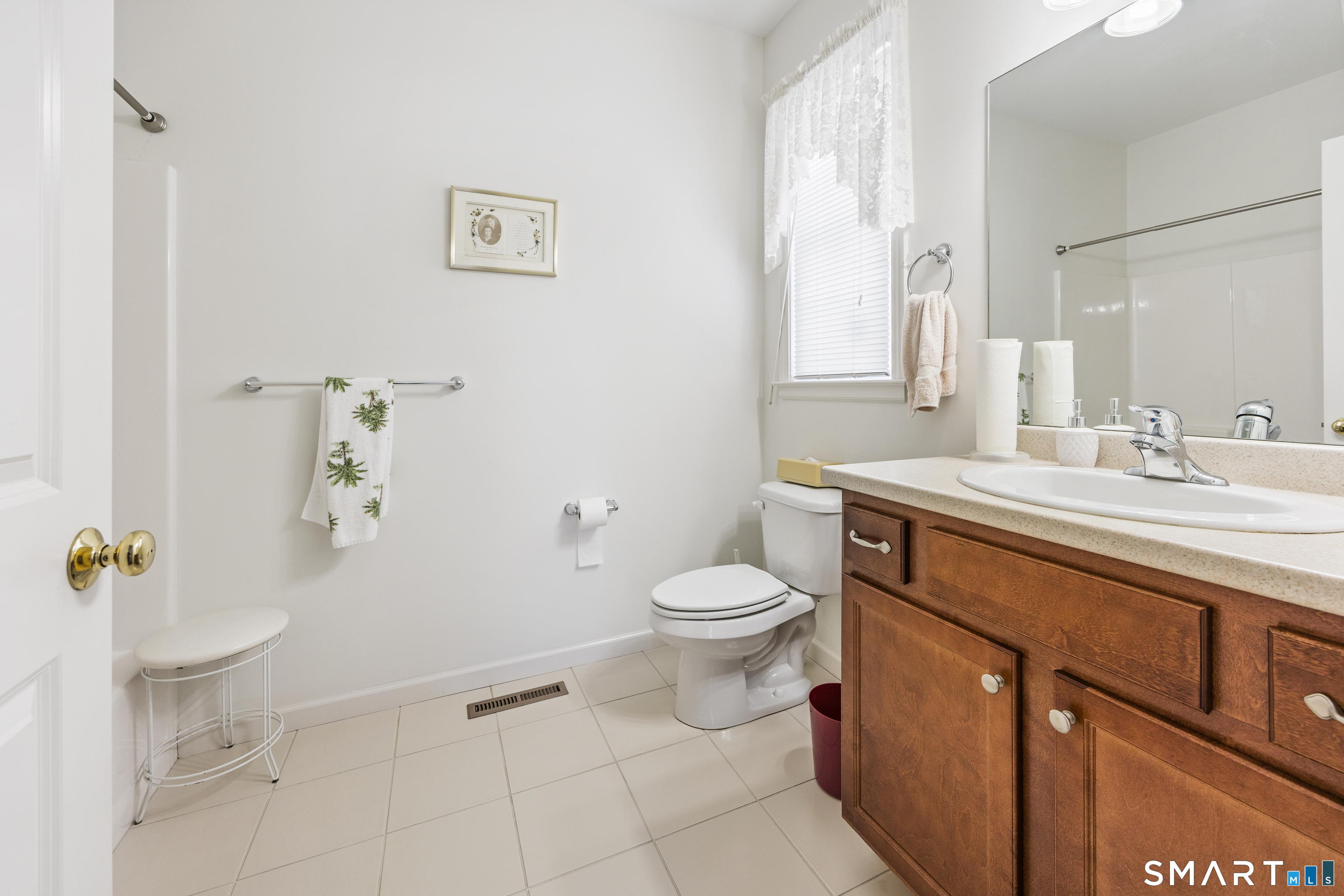 39 Phillips Farm Road, Unit 39 East Hartford, CT 06118 - Photo 10 of 32 a bathroom with a sink toilet and vanity