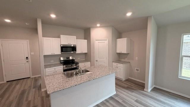 232 Blanco Drive Azle, TX 76020 - Photo 1 of 11 a kitchen with stainless steel appliances granite countertop a stove refrigerator and cabinets