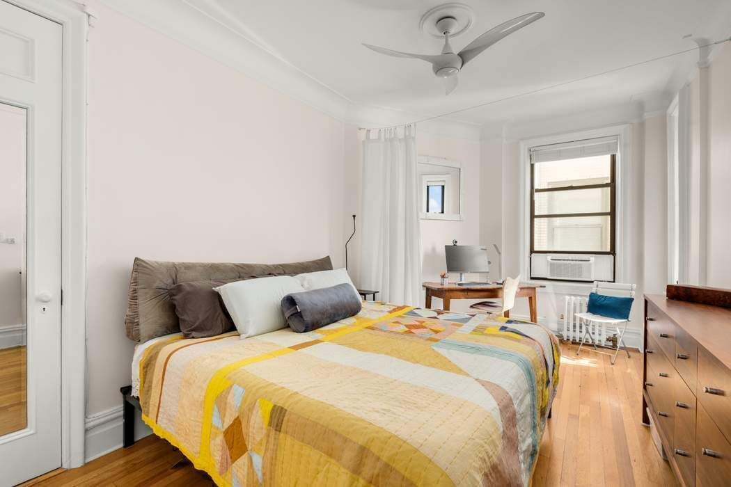 790 Riverside Drive, Unit 12K Manhattan, NY 10032 - Photo 6 of 11 a bedroom with a bed and wooden floor