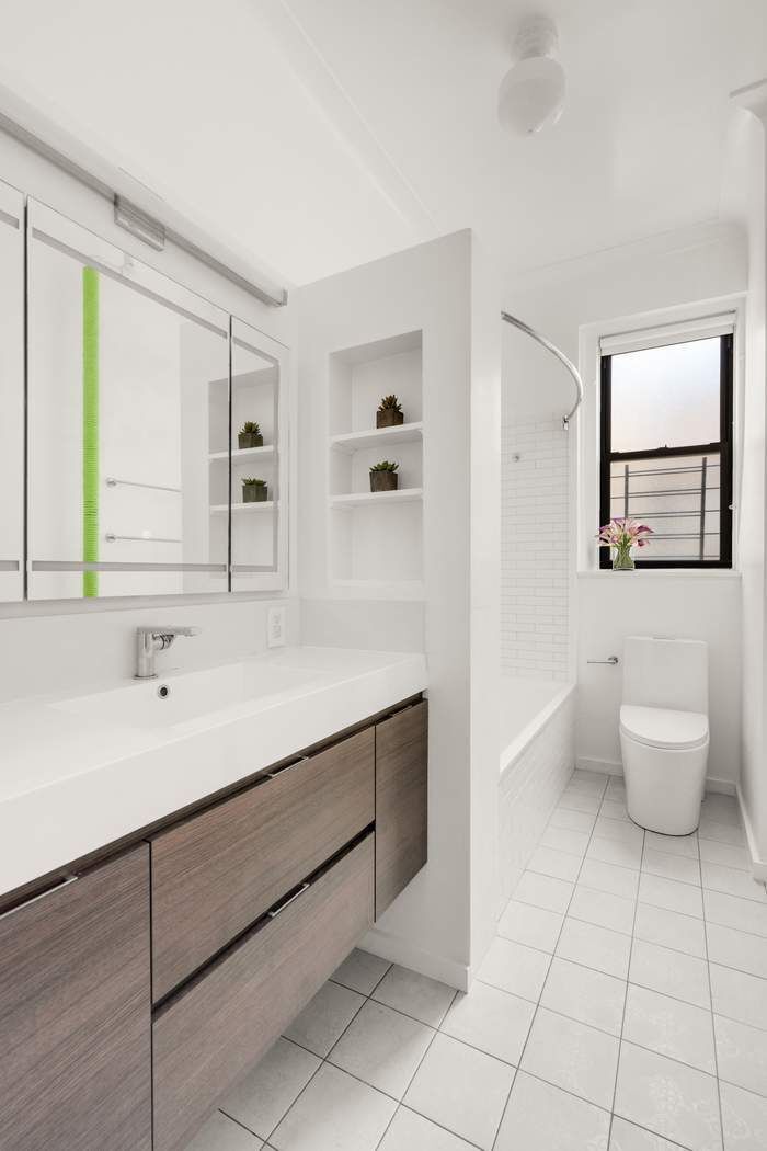 790 Riverside Drive, Unit 12K Manhattan, NY 10032 - Photo 8 of 11 a bathroom with a sink toilet and mirror