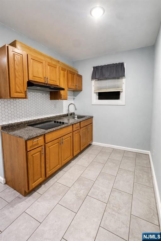 100 Rosa Parks Boulevard, Unit 3 Paterson, NJ 07501 - Photo 8 of 9 a kitchen with stainless steel appliances granite countertop a sink and cabinets