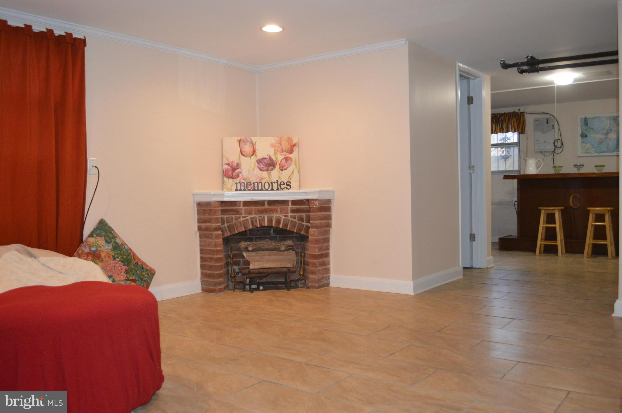 746 Charing Cross Road Baltimore, MD 21229 - Photo 21 of 30 a living room with furniture and a fireplace