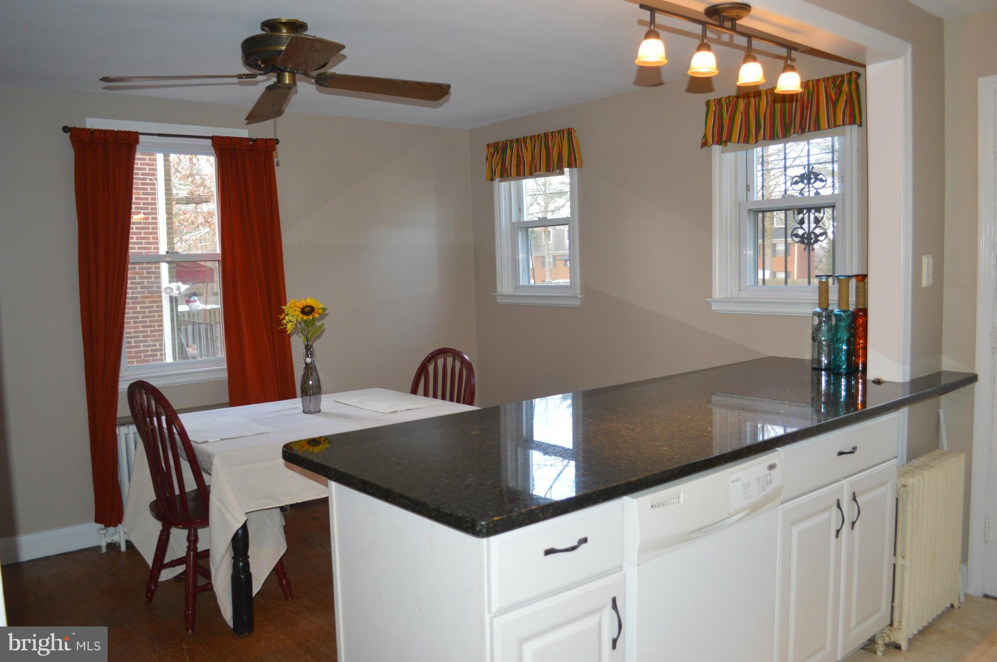 746 Charing Cross Road Baltimore, MD 21229 - Photo 7 of 30 a kitchen with granite countertop a table chairs and window