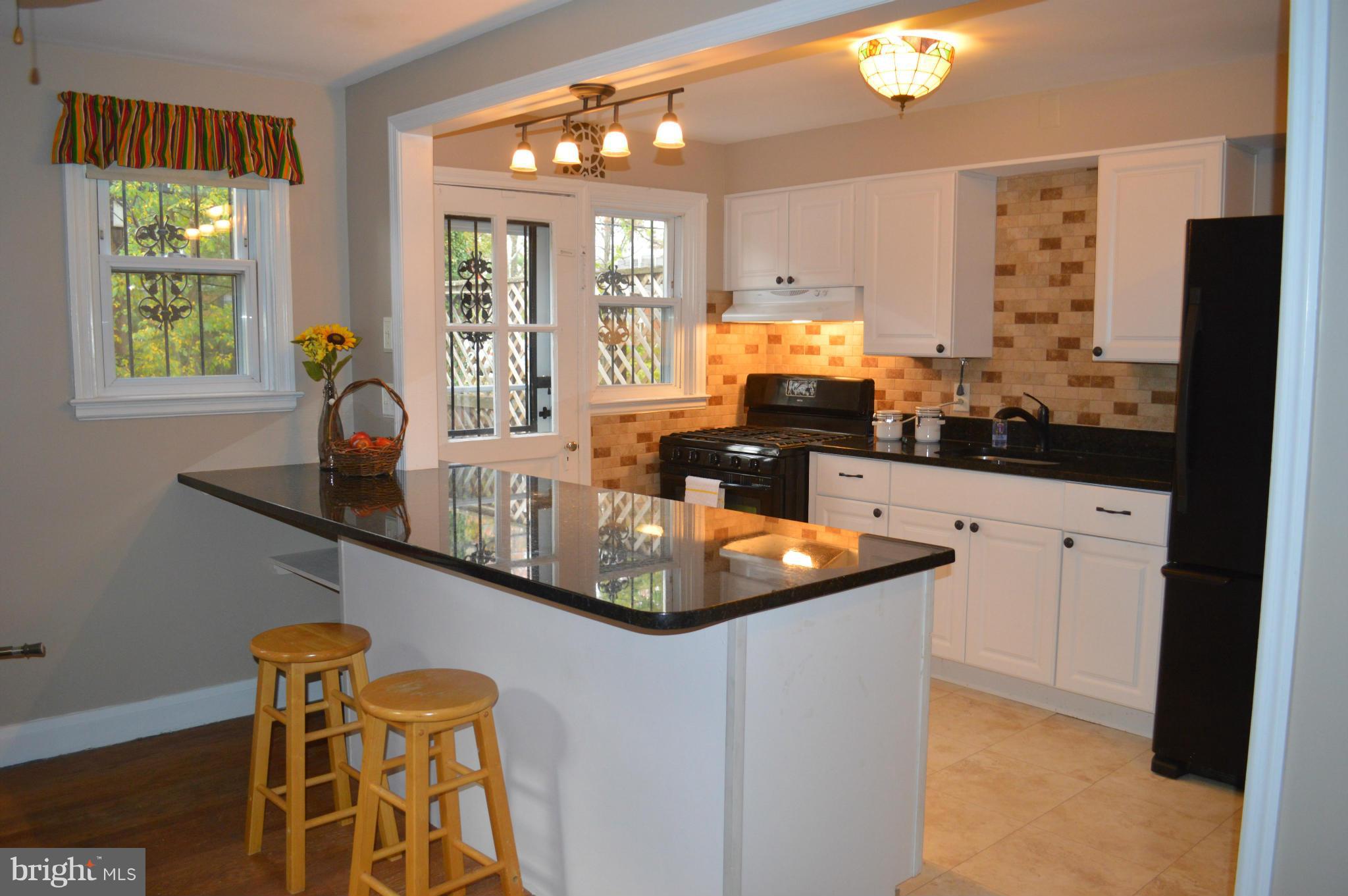 746 Charing Cross Road Baltimore, MD 21229 - Photo 8 of 30 a kitchen with stainless steel appliances granite countertop a sink and a refrigerator