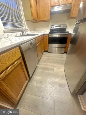 a kitchen with a stove a sink and a microwave