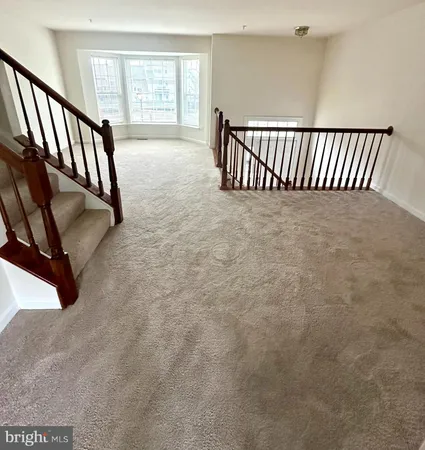 wooden floor with staircase and windows