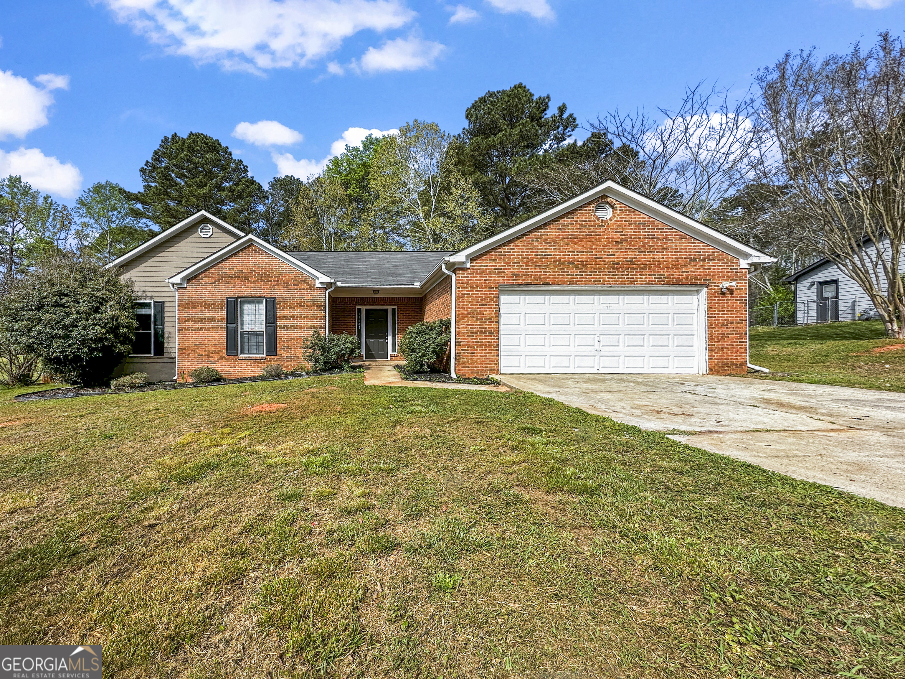 a front view of a house with a garden