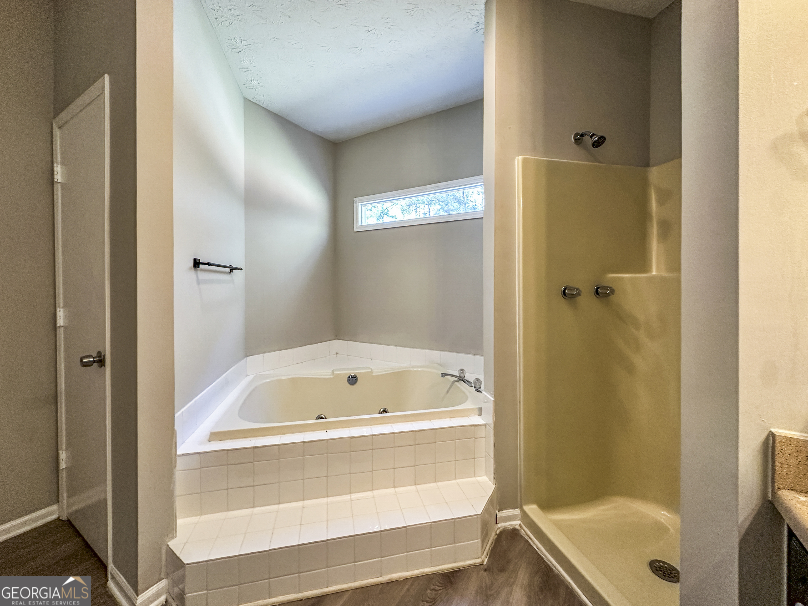 11647 Matthews Trail Hampton, GA 30228 - Photo 11 of 18 a bathroom with a tub and shower