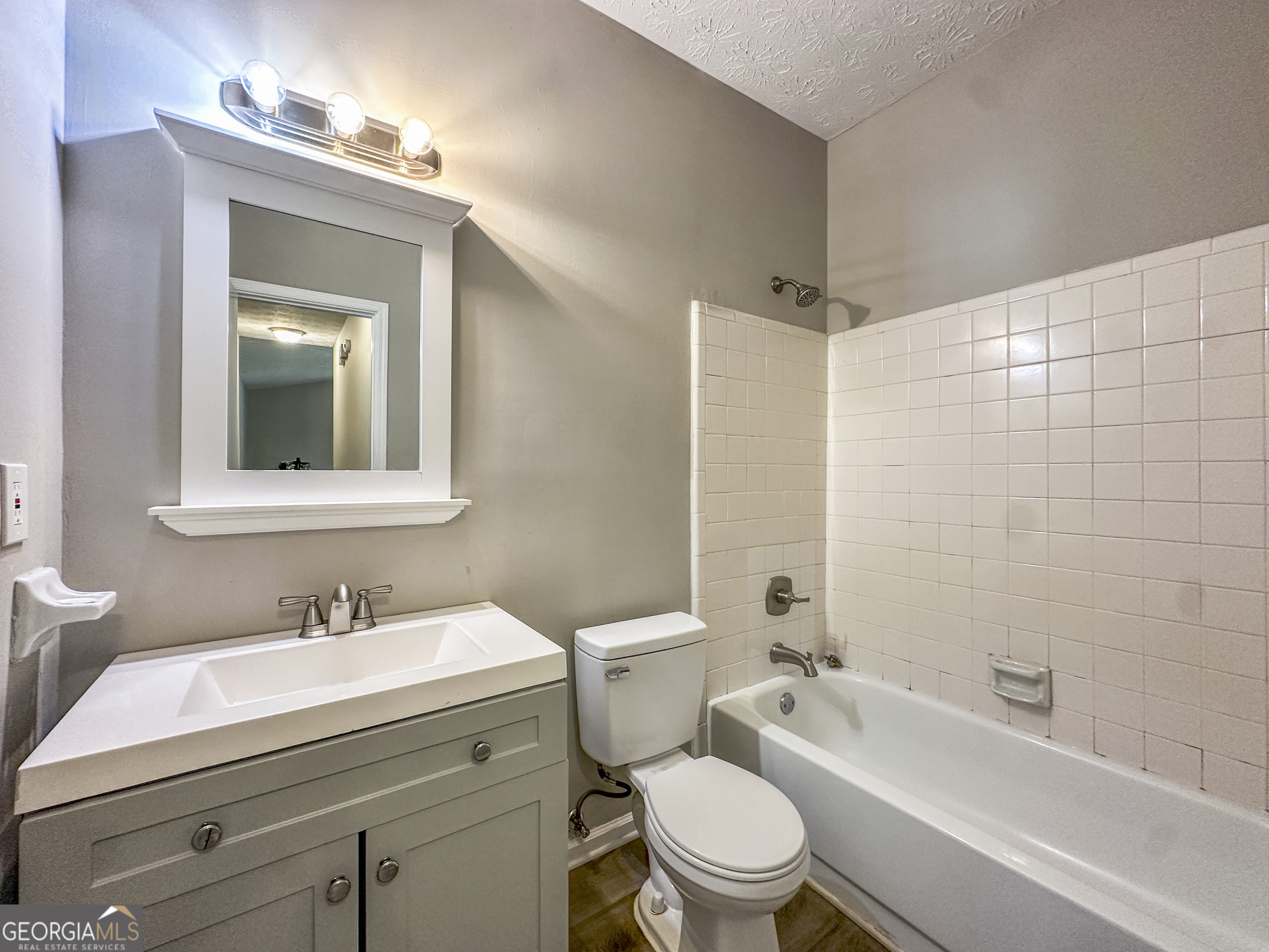11647 Matthews Trail Hampton, GA 30228 - Photo 15 of 18 a bathroom with a sink toilet a mirror and shower