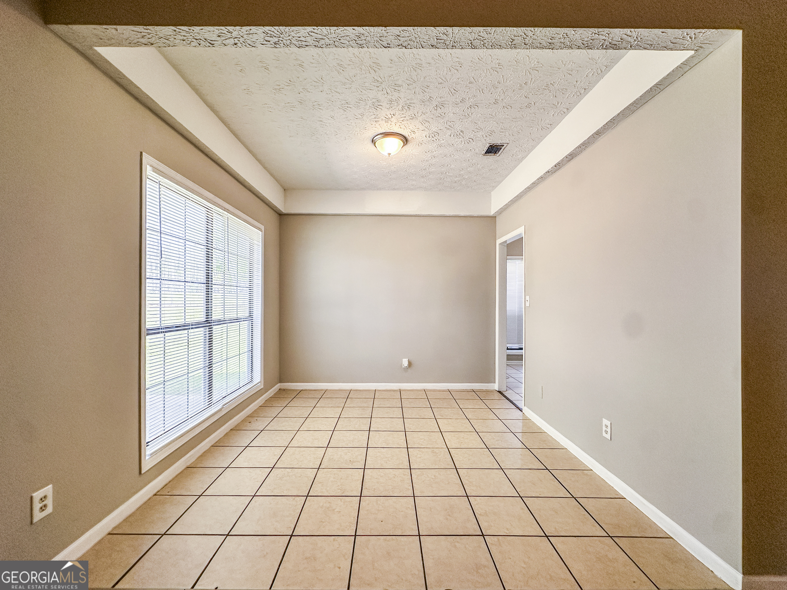 11647 Matthews Trail Hampton, GA 30228 - Photo 5 of 18 a view of an empty room and window
