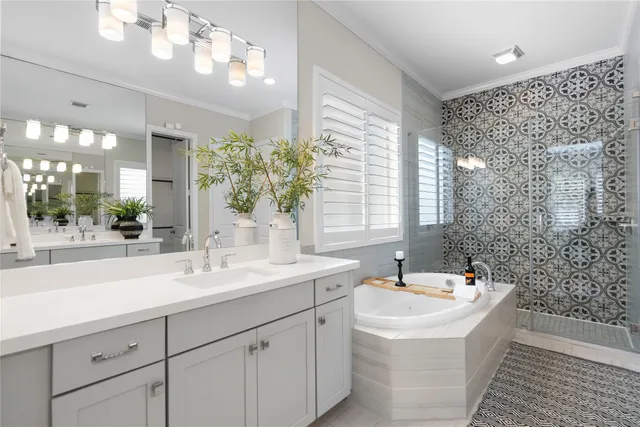 a bathroom with a sink a large mirror and shower