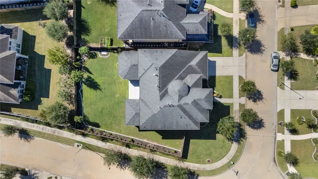 an aerial view of a house with a yard and a fountain